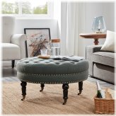 Gray Tufted Round Ottoman with Caster Wheels